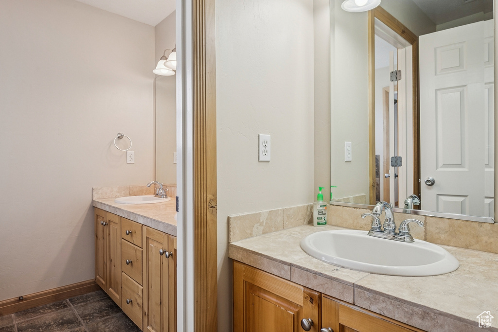 Bathroom featuring vanity and baseboards