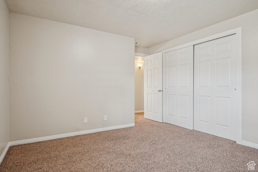 Unfurnished bedroom with carpet floors and a closet