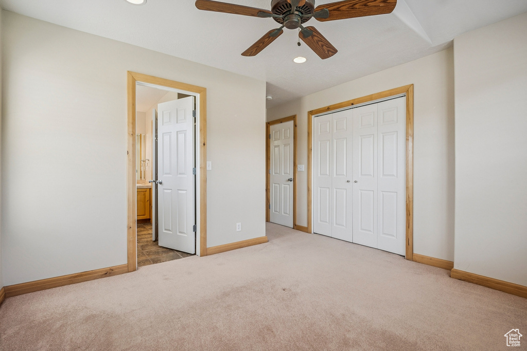 Unfurnished bedroom featuring carpet flooring, a closet, recessed lighting, ensuite bathroom, and a ceiling fan