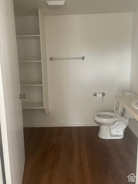 Bathroom featuring wood finished floors and toilet