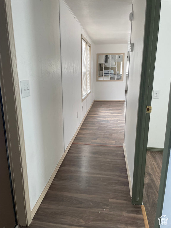 Hall with wood finished floors and baseboards