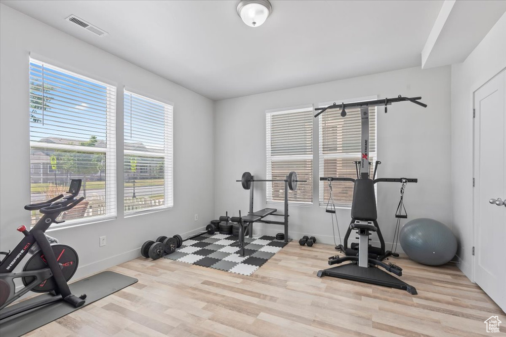 Exercise room featuring wood finished floors and healthy amount of natural light