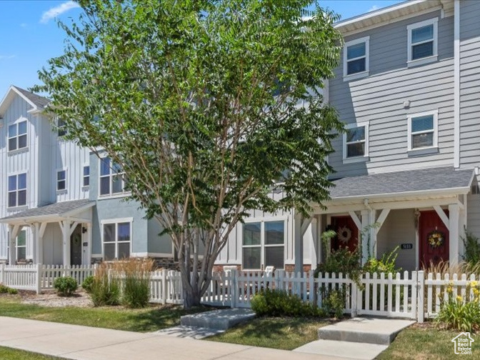Multi unit property featuring a residential view and a fenced front yard