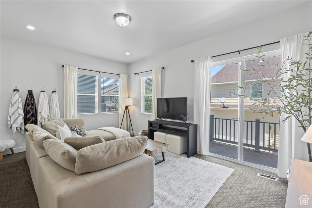 Carpeted living area featuring recessed lighting