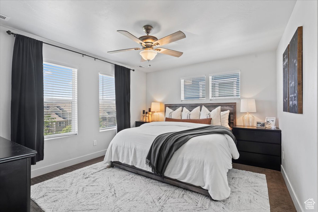 Carpeted bedroom with baseboards and ceiling fan