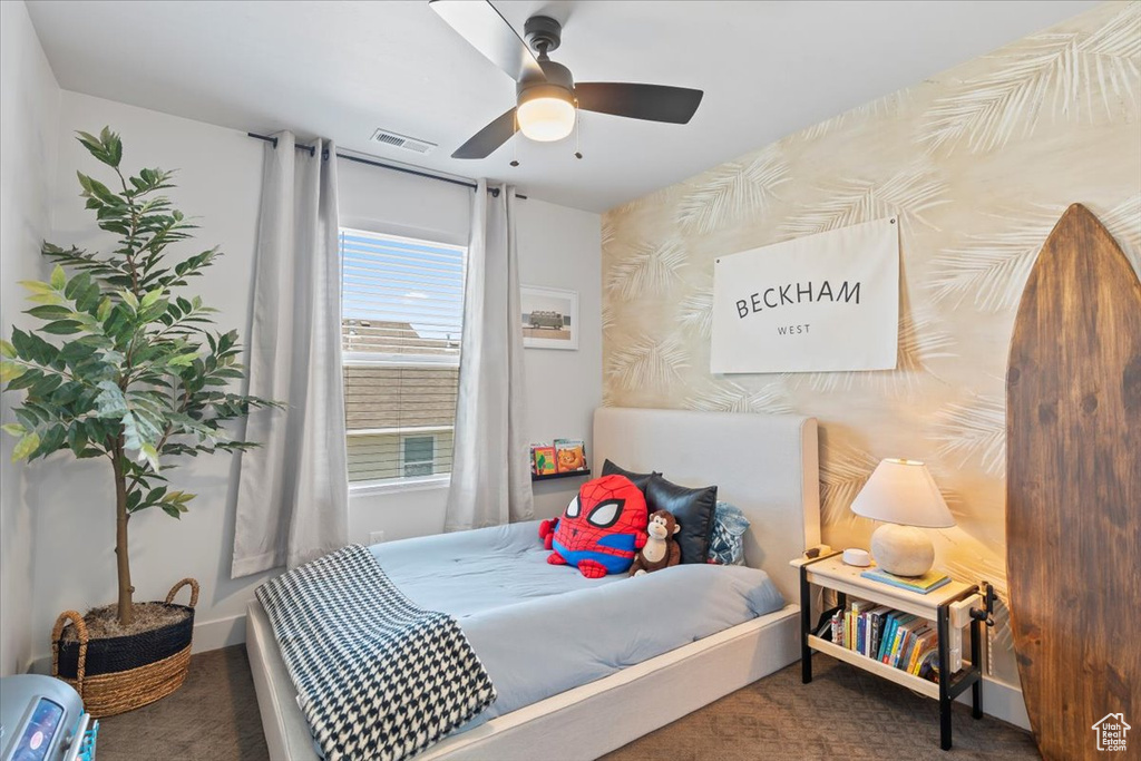 Carpeted bedroom with ceiling fan