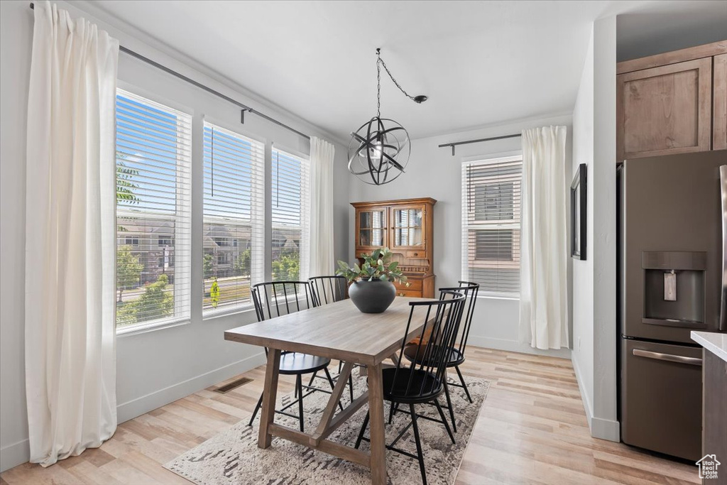 Dining room with a chandelier and light wood-style flooring