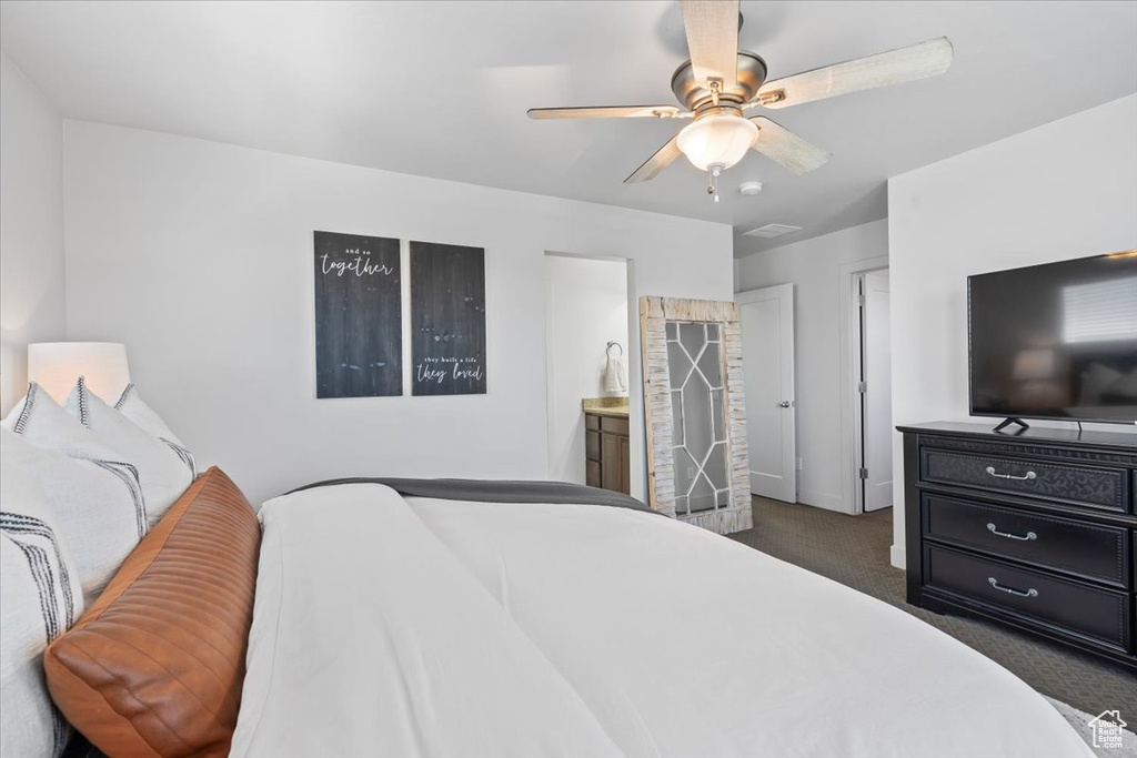 Bedroom featuring carpet floors, a ceiling fan, and connected bathroom