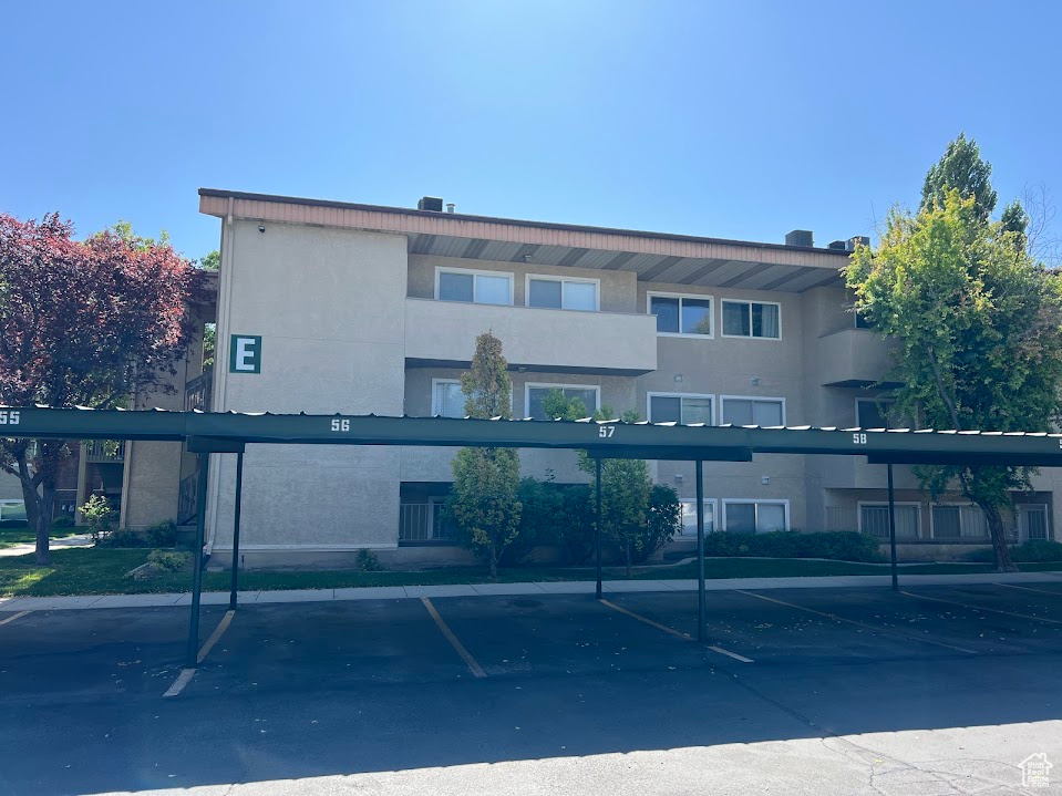 View of property with covered parking