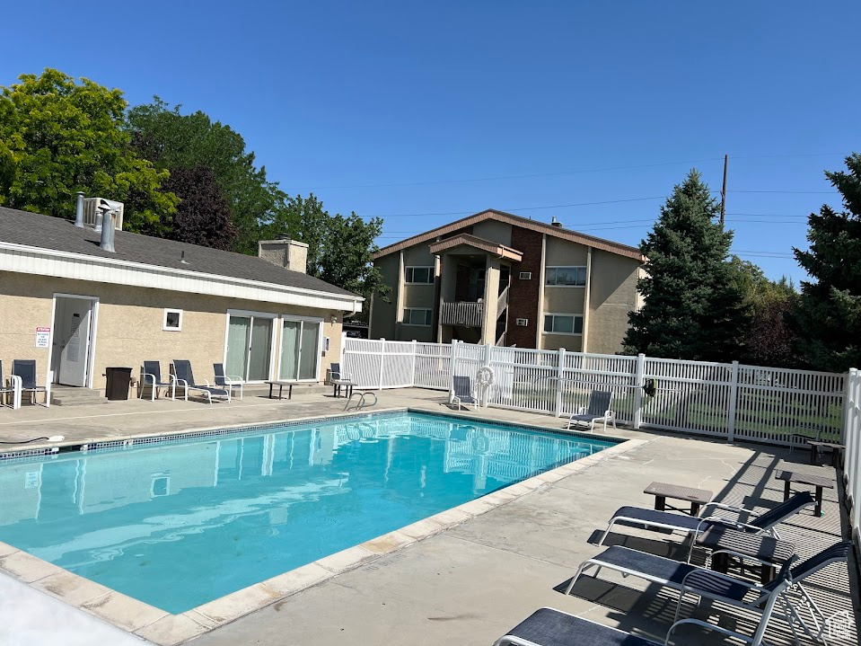 Community pool with a patio