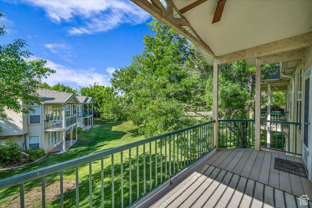 Wooden deck with a ceiling fan and a yard