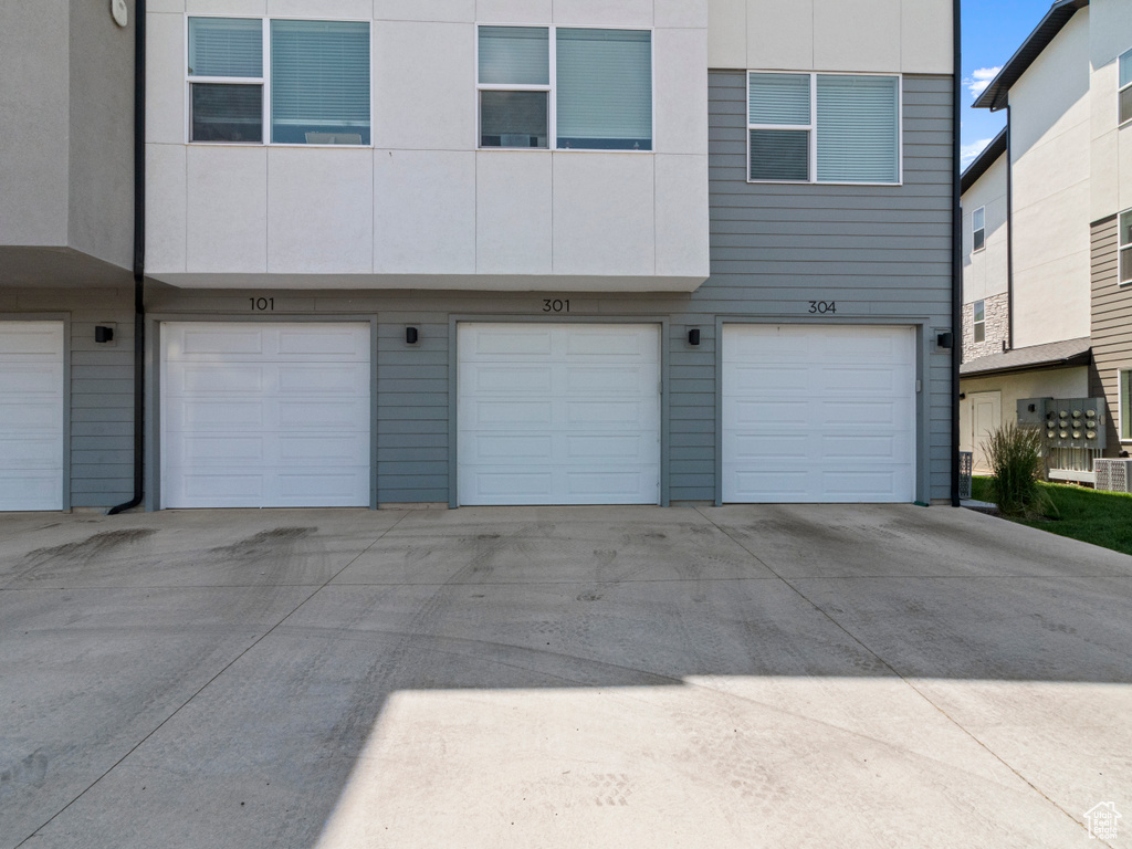 Rear view of house with a garage and driveway