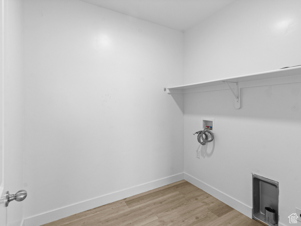 Washroom with washer hookup and light wood-style floors