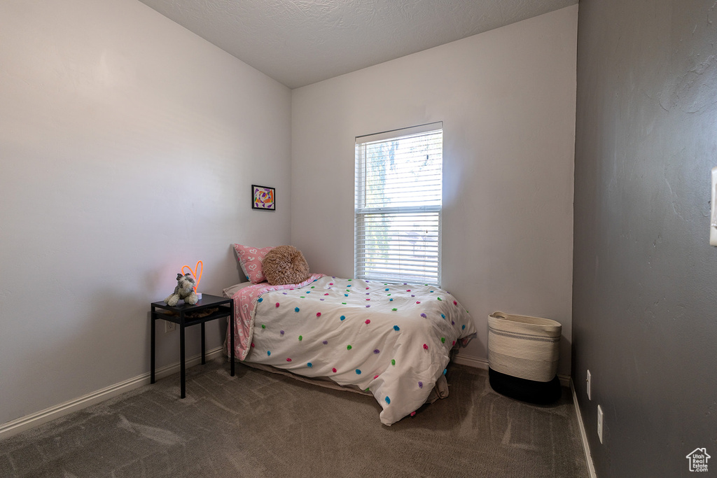 Bedroom with carpet flooring and baseboards