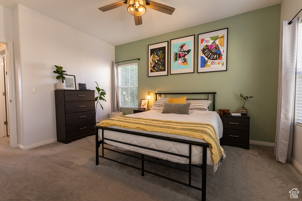 Bedroom featuring light carpet and ceiling fan