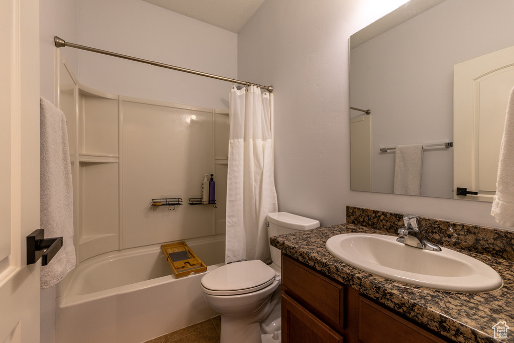 Full bathroom with vanity, shower / tub combo with curtain, and tile patterned flooring