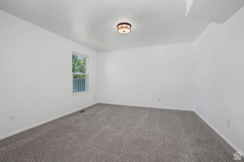 Spare room featuring carpet flooring