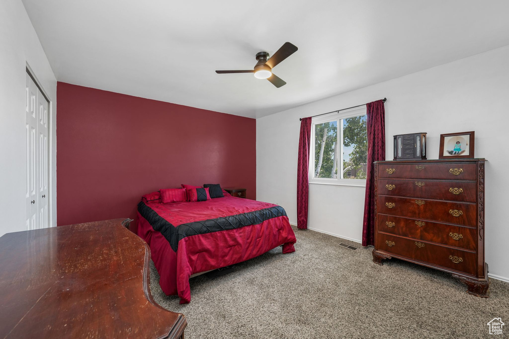 Bedroom with carpet floors, a closet, and ceiling fan