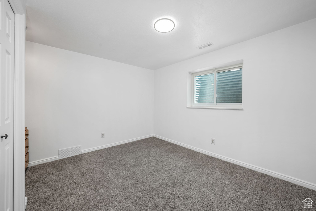 Carpeted empty room with baseboards