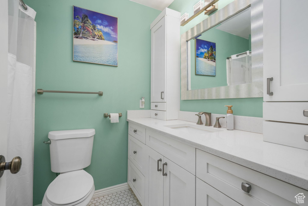 Full bath featuring vanity and tile patterned floors
