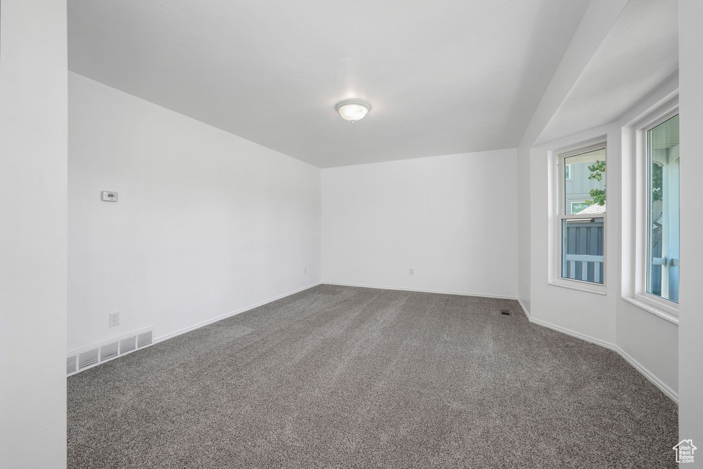 Carpeted empty room with baseboards