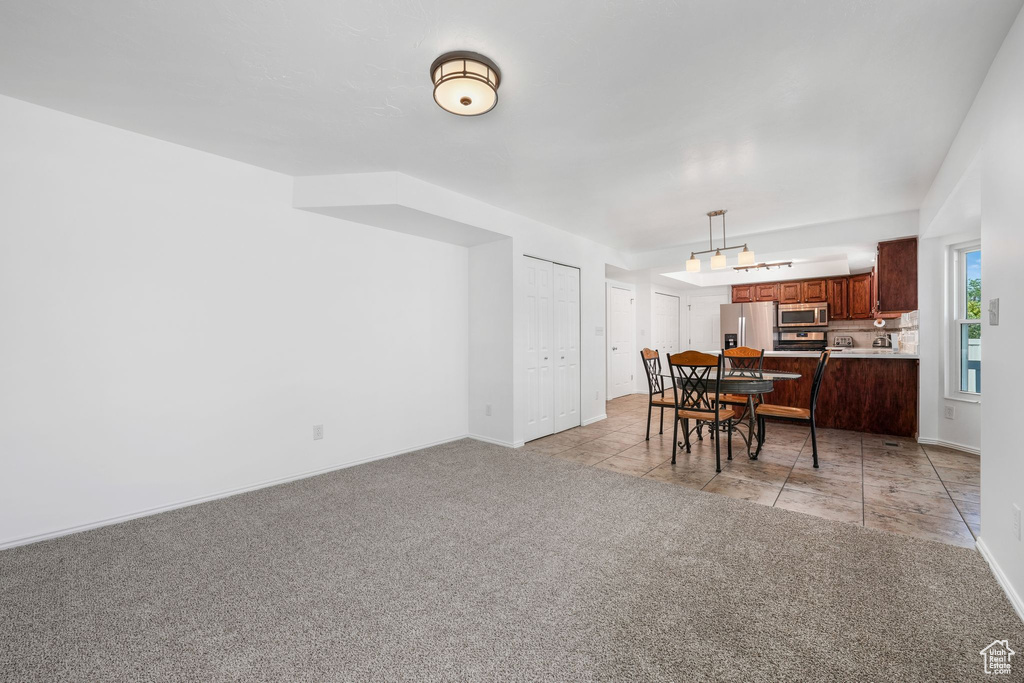 Dining room with light carpet and baseboards