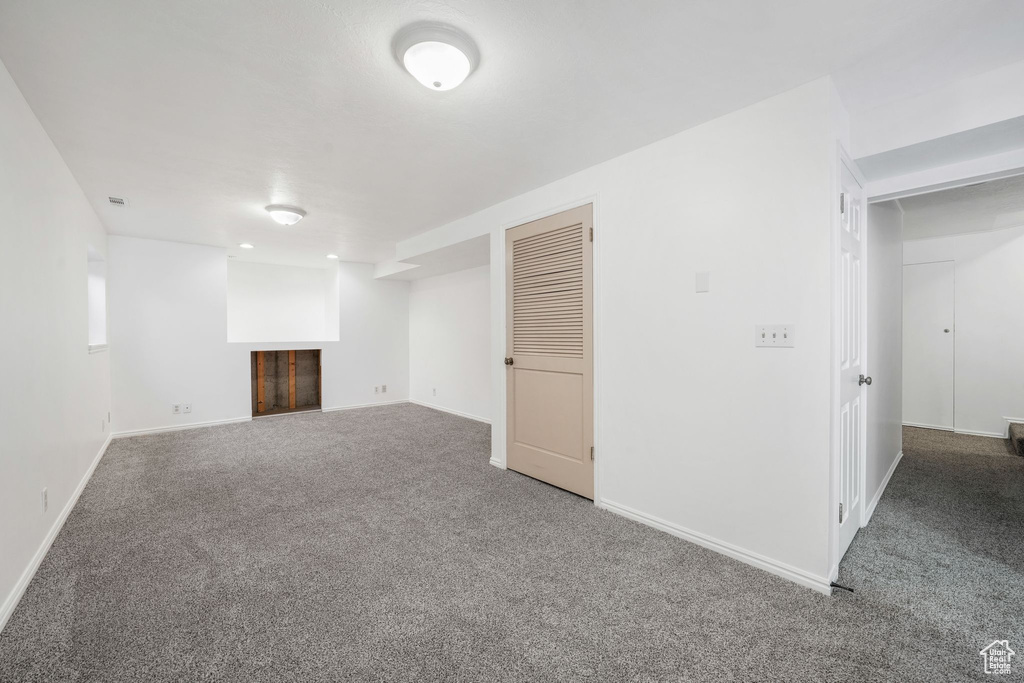 Finished basement featuring carpet and a fireplace