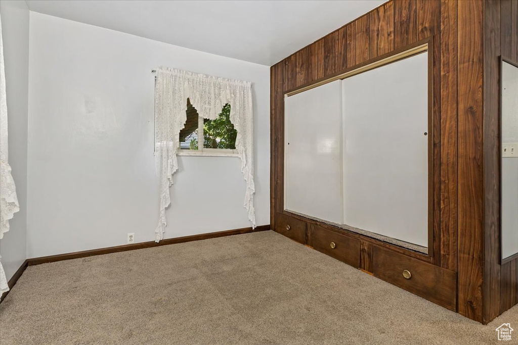 Carpeted spare room with baseboards