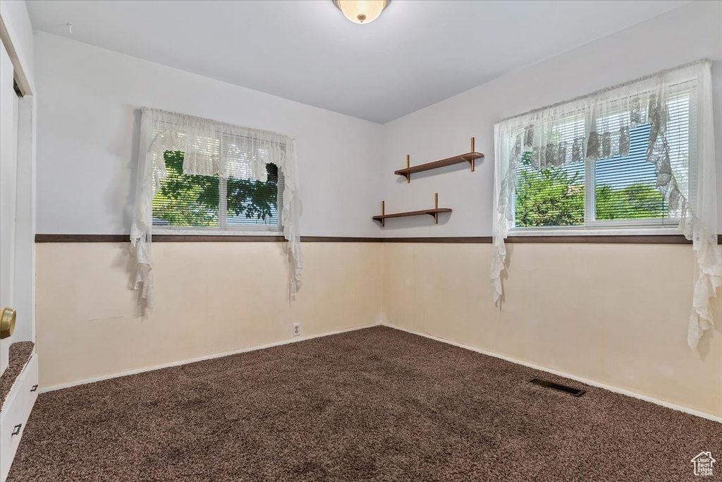 Empty room with dark carpet
