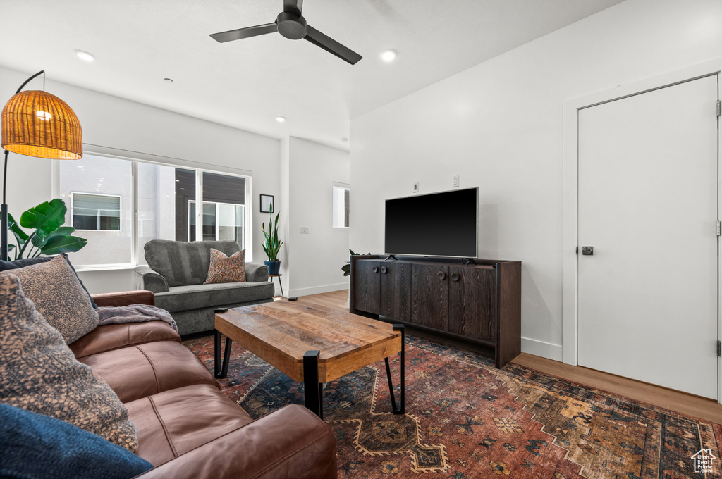 Living area with wood finished floors, ceiling fan, and recessed lighting