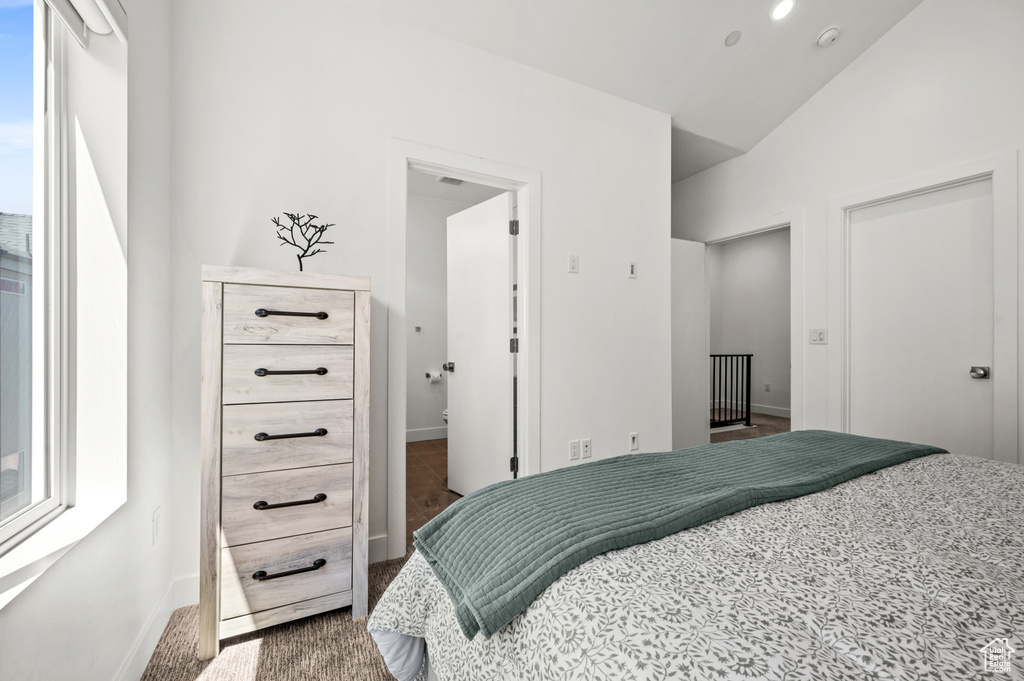 Bedroom featuring carpet flooring and lofted ceiling