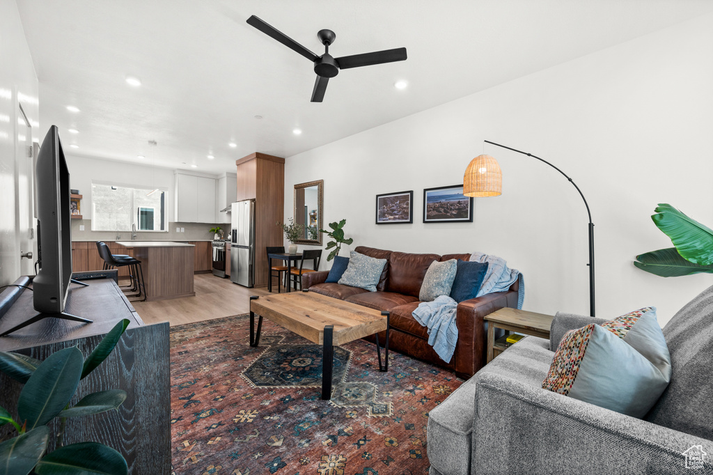 Living area featuring ceiling fan, light wood finished floors, and recessed lighting