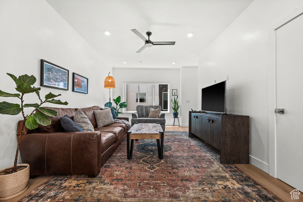 Living room with ceiling fan, wood finished floors, and recessed lighting