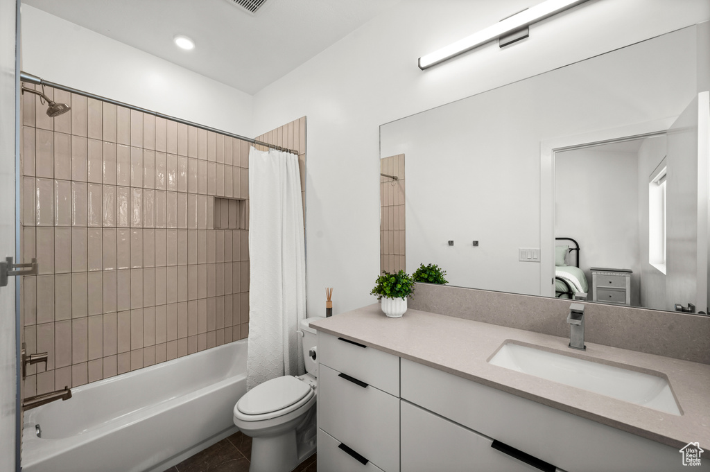 Bathroom with vanity, shower / bath combination with curtain, and tile patterned floors