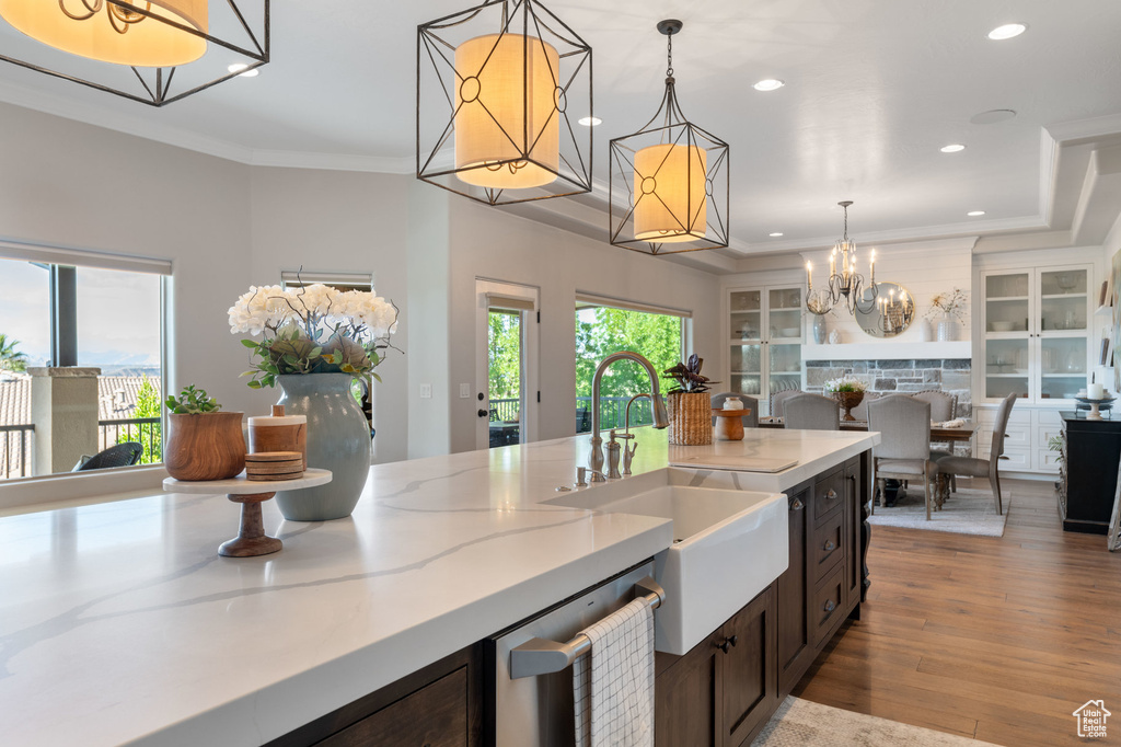 Kitchen with a chandelier, stainless steel dishwasher, open floor plan, recessed lighting, and hanging light fixtures