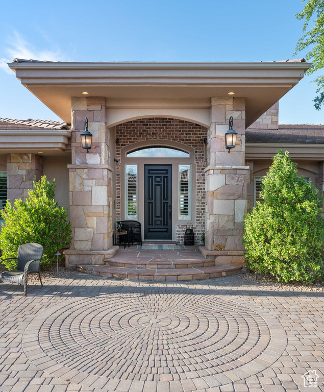 Doorway to property with stone siding