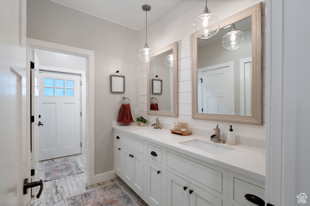 Bathroom with double vanity and baseboards