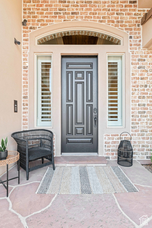 Property entrance featuring brick siding