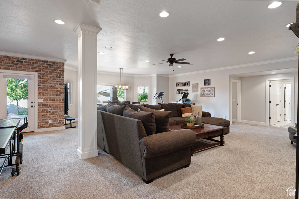 Living room featuring light colored carpet, crown molding, recessed lighting, and a ceiling fan