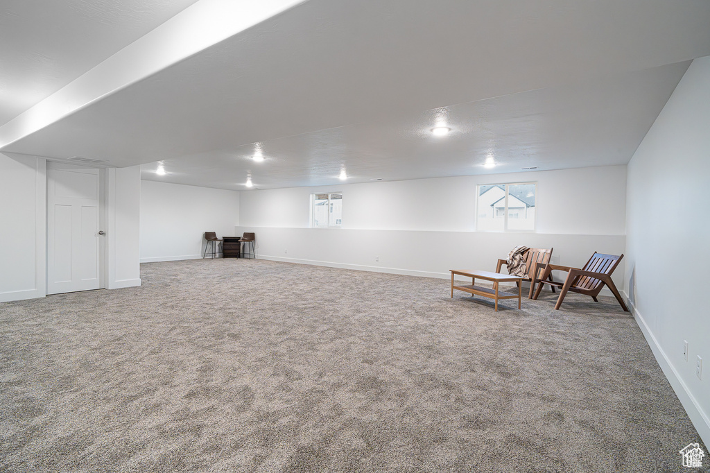 Basement featuring carpet flooring and baseboards