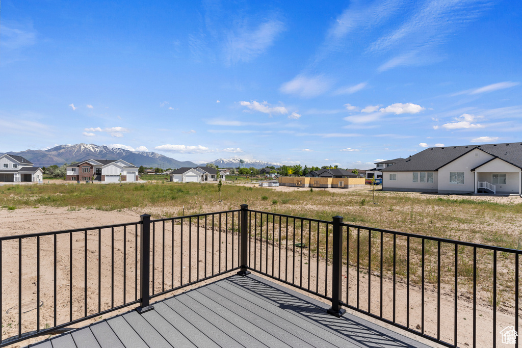 Deck with a residential view and a mountain view