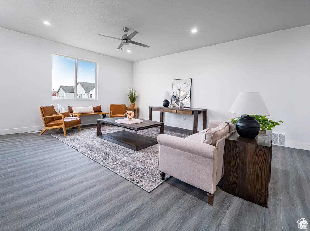Living area with wood finished floors, ceiling fan, and recessed lighting