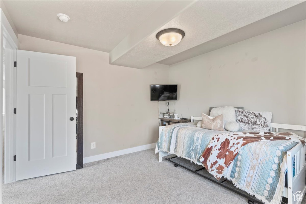 Bedroom with carpet floors and a textured ceiling