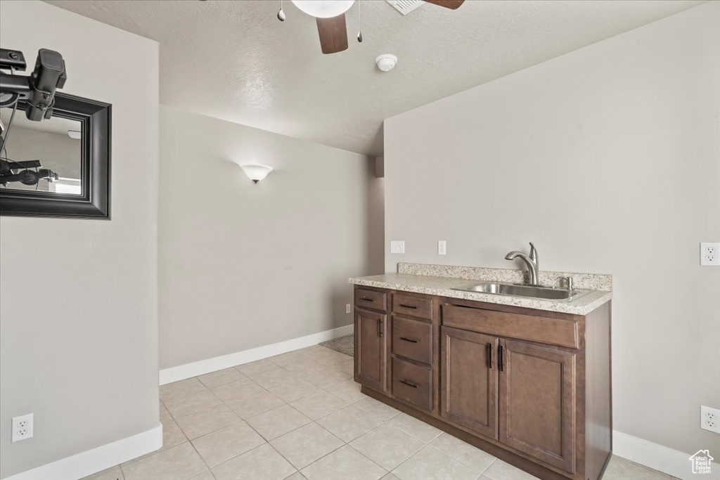 Bathroom featuring ceiling fan, vanity, and tile patterned flooring