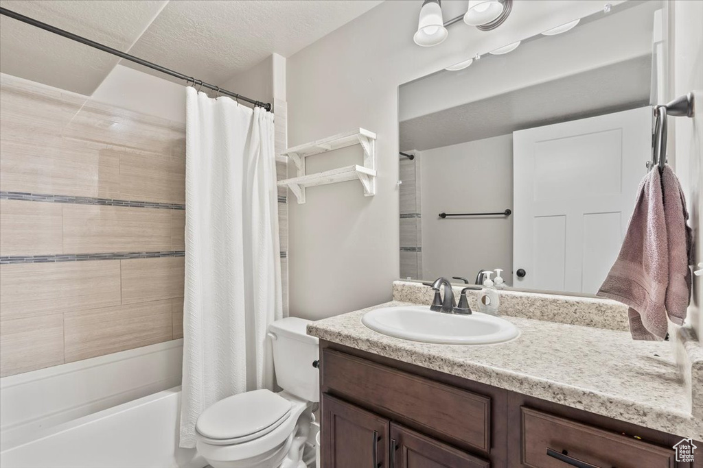 Full bathroom featuring vanity and shower / bath combo with shower curtain