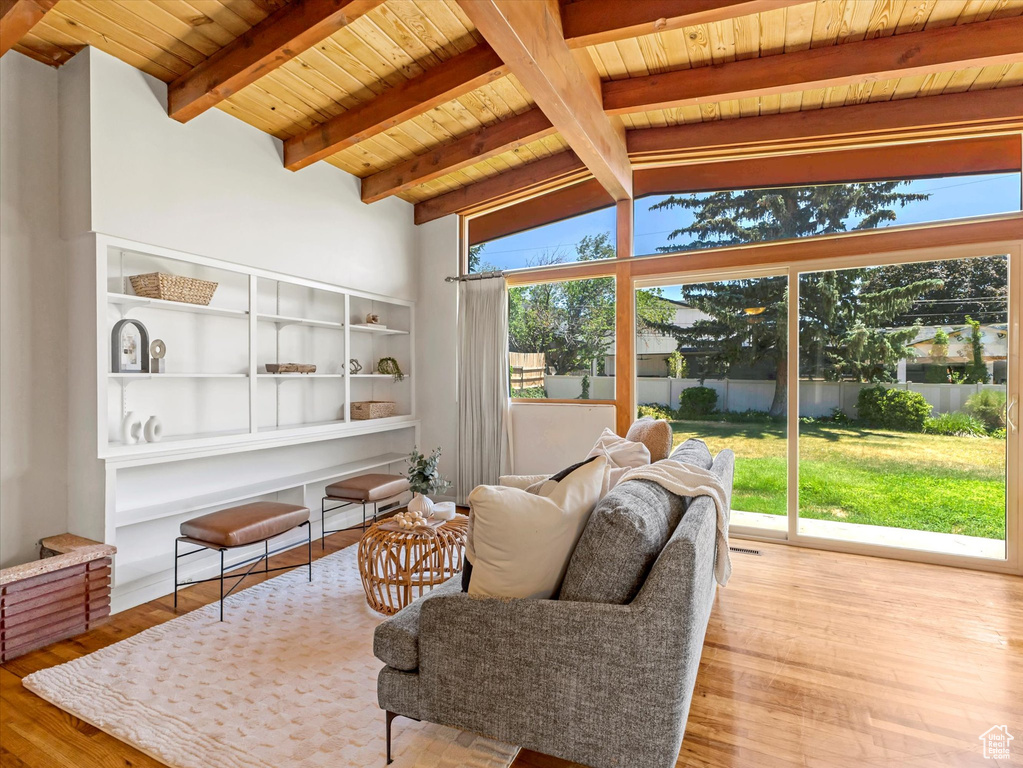 Living room with wooden ceiling and wood finished floors