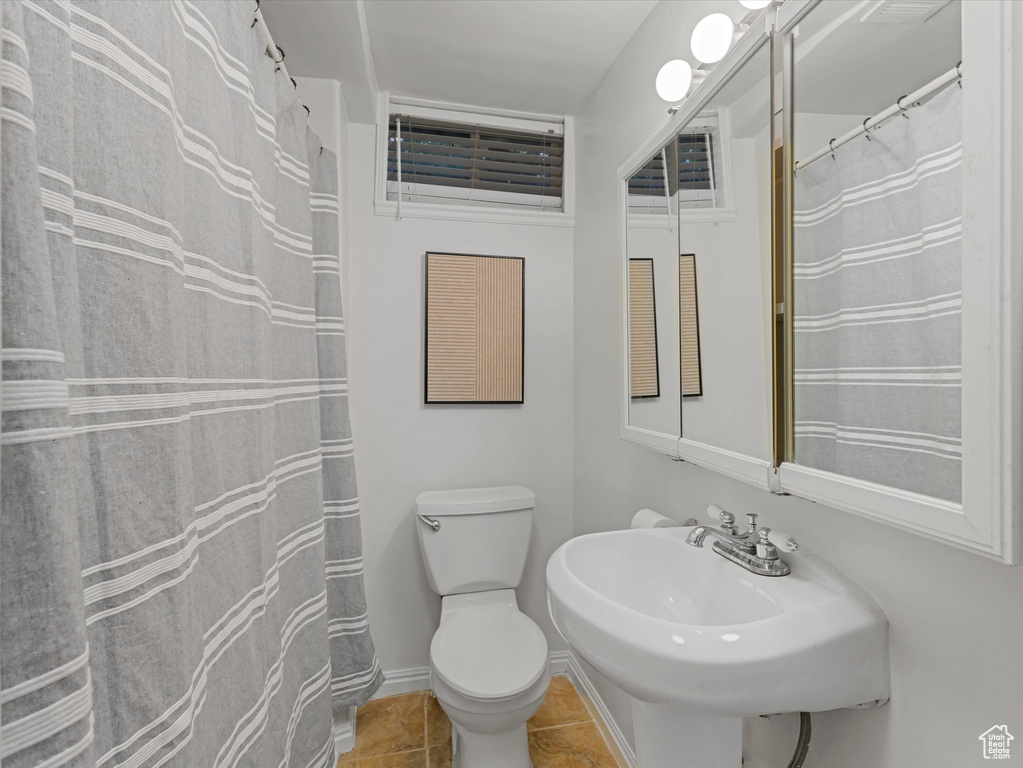 Bathroom with a sink and tile patterned flooring