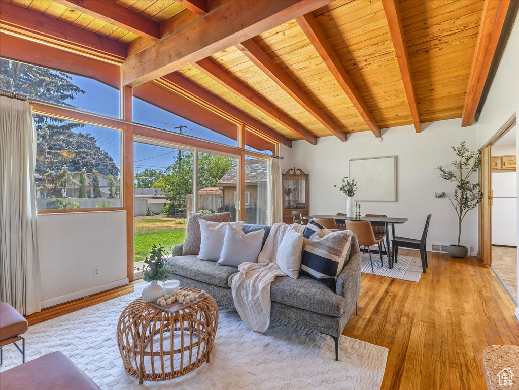 Living area with light wood finished floors and wooden ceiling