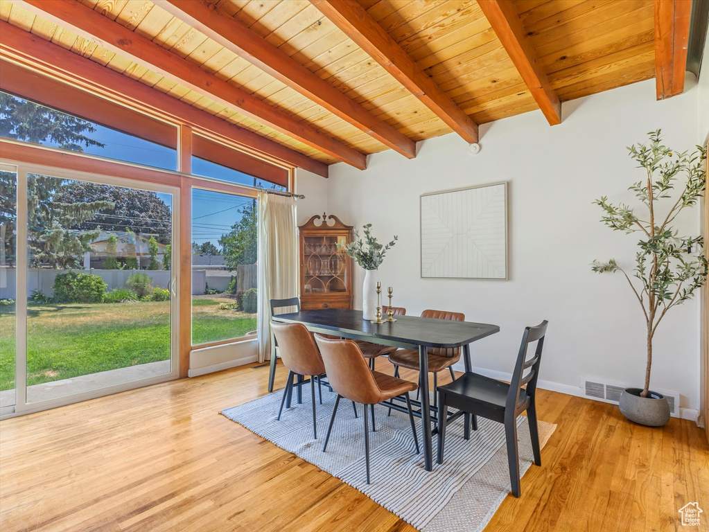 Dining space with light wood-style floors and wood ceiling