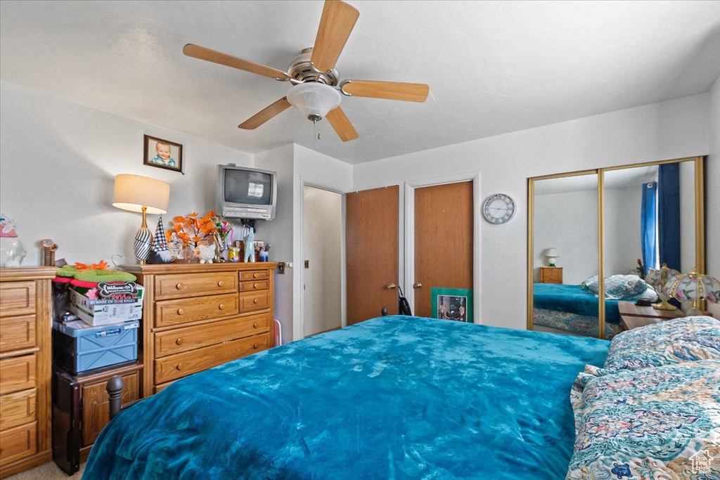 Bedroom featuring multiple closets and ceiling fan